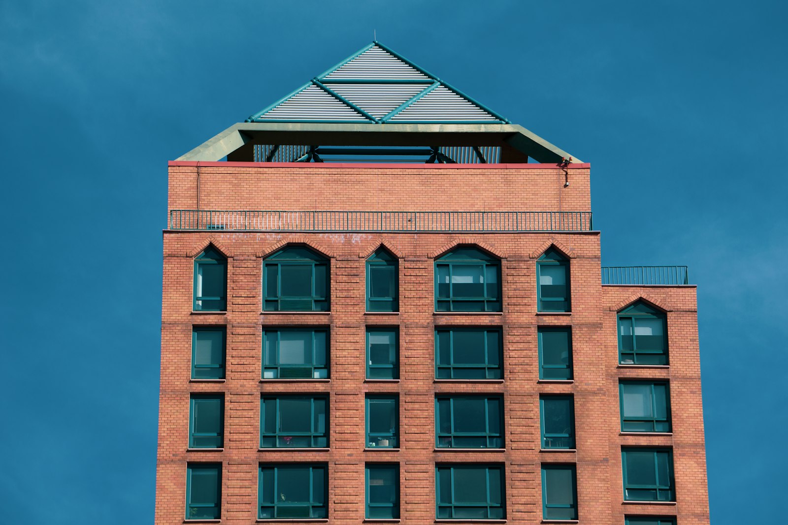 a tall brick building with a sky background